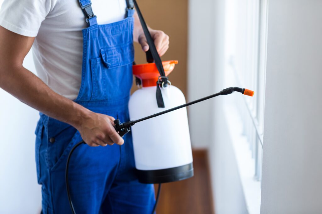 Man holding an Exterminator Spray Tank